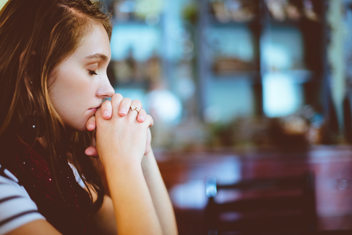Woman Praying at a Church